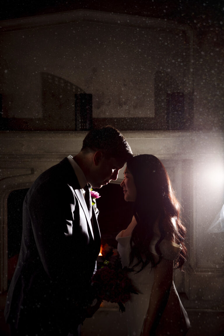 Wedding couple in front of fireplace at the lake house